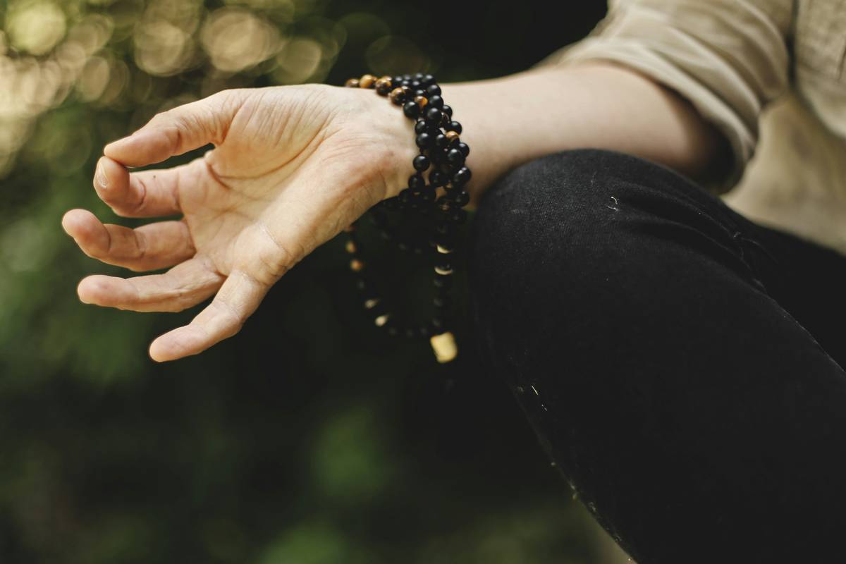 Woman practicing Quiet Reflection at sunrise with calm expression