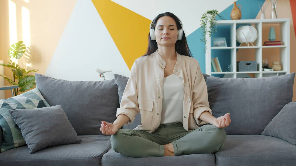 Woman practicing Breath Awareness while holding a soft relax ball, eyes closed, seated calmly